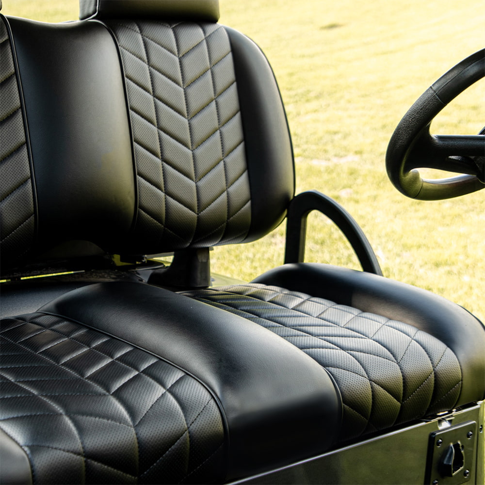 Detailed view of a black Aviator front seat assembly installed on a golf cart.