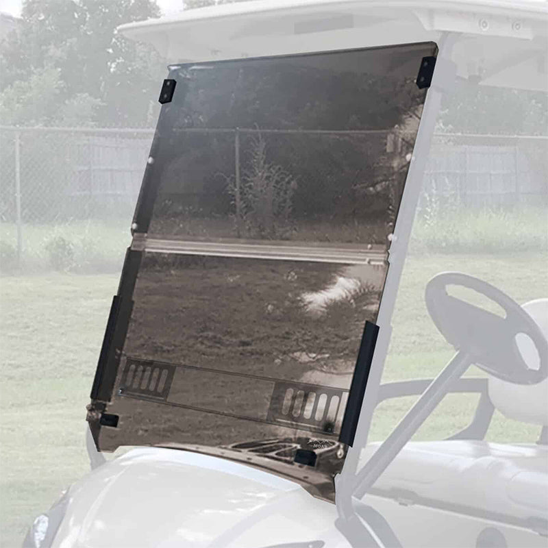 The MOAB Yamaha Drive folding tinted vented windshield installed on a white G29/Drive golf cart, parked in a yard, offered for sale with free shipping and best pricing by Salt City Golf Cart in Hutchinson, Kansas.